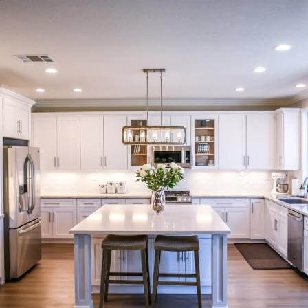 Modern kitchen remodel with white cabinets and stainless steel appliances
