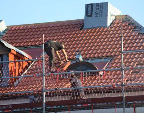 Roof repair service with patched leaks, re-shingled sections, and clear flashing