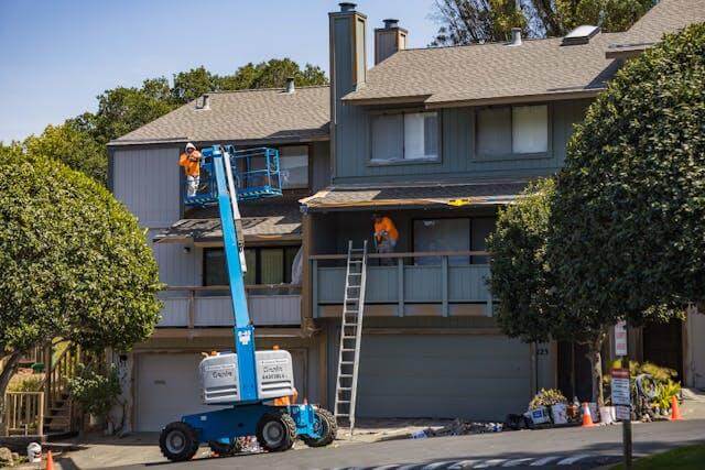 Professional roofing maintenance with cleaning, re-caulking, and gutter checks