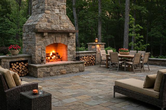 Custom outdoor fireplace with stone veneer and built-in seating area